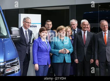 Hanover, Germany. 24th Apr, 2017. German Chancellor Angela Merkel (2nd L, front) and Polish Prime Minister Beata Szydlo (1st L, front) visit the booth of Volkswagen during the Hanover Messe 2017 in Hanover, Germany, April 24, 2017. The Hanover Messe 2017, with the lead theme 'Integrated Industry -- Creating Value' and Poland as the official Partner Country, will last until April 28. Credit: Shan Yuqi/Xinhua/Alamy Live News Stock Photo
