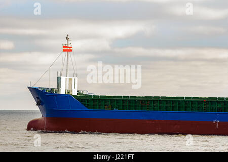 Blue cargo ship's bow leaving the port of Riga Stock Photo