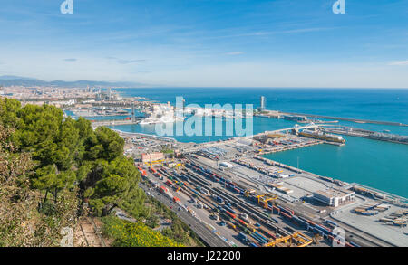 Bright sunny day on the industrial shipping & transport hub & railyard in Barcelona.  Modern cityscape & coastline of Spain. Stock Photo