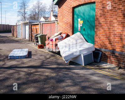 Fly tipping - Household waste and rubbish dumped at a fly tip in an urban area Stock Photo