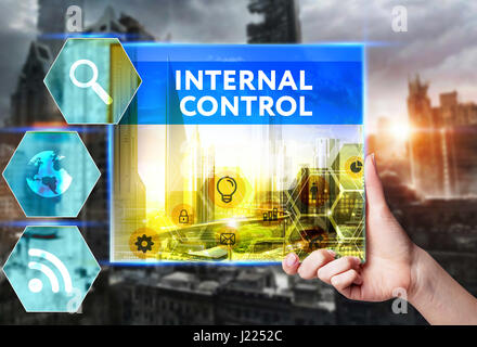 Technology, internet, business and marketing. Young business woman writing word: Internal control Stock Photo