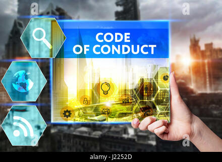 Technology, internet, business and marketing. Young business woman writing word: Code of conduct Stock Photo