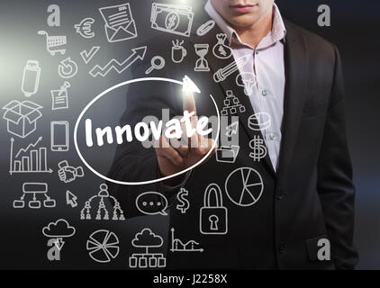 Business, Technology, Internet and network concept. Business man working on the tablet of the future, select on the virtual display: innovate Stock Photo