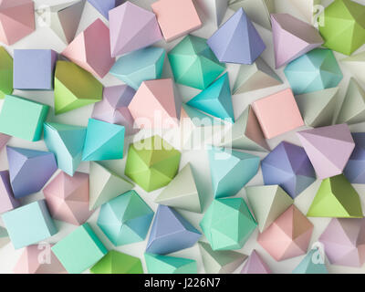 Colorful abstract geometric background with three-dimensional solid figures. Pyramid Dodecahedron prism rectangular cube arranged on white paper. Stock Photo