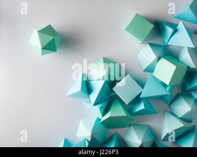Colorful abstract geometric background with three-dimensional solid figures. Pyramid Dodecahedron prism rectangular cube arranged on white paper.