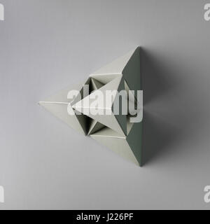 grey pyramid made from tetrahedron geometry models on green background ...