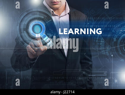 Business, Technology, Internet and network concept. Business man working on the tablet of the future, select on the virtual display: learning Stock Photo