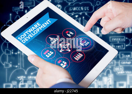 Business, technology, internet and networking concept. Young businessman working on his laptop in the office, select the icon software development on  Stock Photo