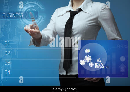 Business woman clicks on the buttons on the virtual screen Stock Photo