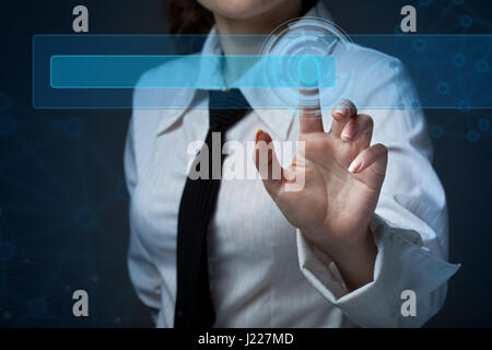 Business woman clicks on the buttons on the virtual screen Stock Photo