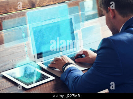 Business, technology internet and networking concept. Young businessman working on his laptop in the office. Stock Photo
