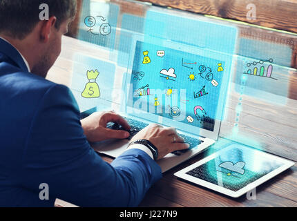 Business, technology internet and networking concept. Young businessman working on his laptop in the office. Stock Photo