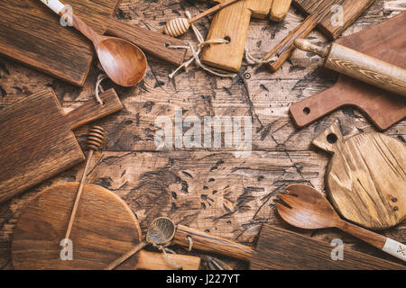 various wooden cutting boards on wooden kitchen table. Top view Stock Photo