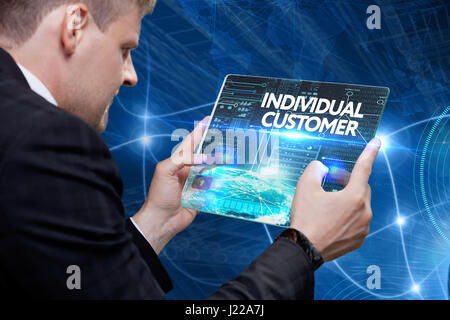 Business, technology, internet and networking concept. Young businessman working on his laptop in the office, select the icon individual customer on t Stock Photo