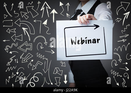 Technology, internet, business and marketing. Young business woman writing word: webinar Stock Photo