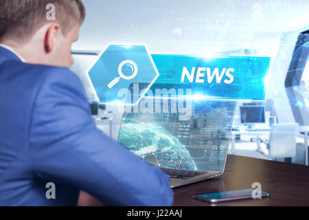 Business, technology, internet and networking concept. Young businessman working on his laptop in the office, select the icon news on the virtual disp Stock Photo