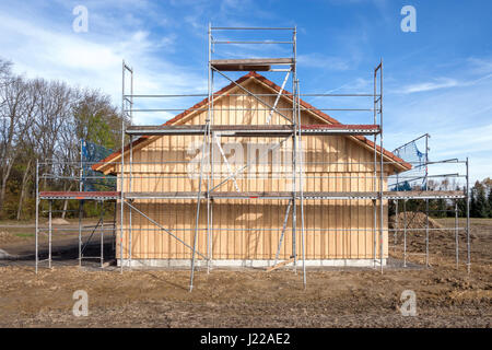 Scaffolding at a new wooden house Stock Photo