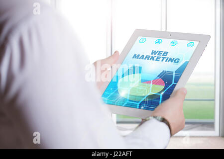 Business, Technology, Internet and network concept. Young business man, working on the tablet of the future, select on the virtual display: Web Market Stock Photo