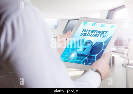 Business, Technology, Internet and network concept. Young business man, working on the tablet of the future, select on the virtual display: Internet S Stock Photo