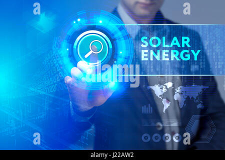 Business, Technology, Internet and network concept. Business man working on the tablet of the future, select on the virtual display: Solar energy Stock Photo