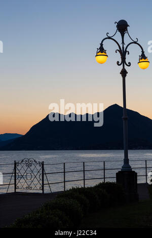 Ornate lamppost on lakeside promenade with stunning views at dawn at Stresa, Lake Maggiore Italy in April Stock Photo