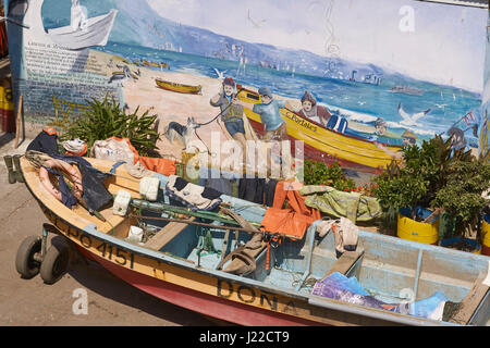 Colourful wooden fishing boats in the fish market of the UNESCO World Heritage port city of Valparaiso in Chile. Stock Photo