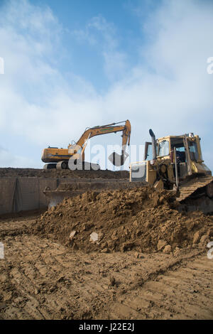 Excavator fills HESCO defensive barriers at Smardan, Romania, for ...