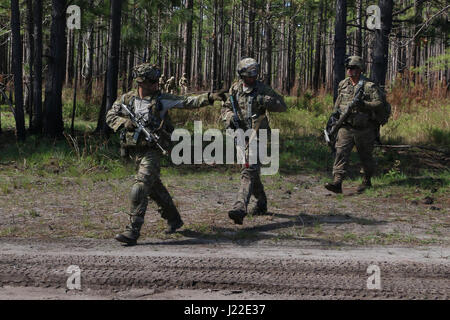 Soldiers with Charlie troop, 6th Squadron, 8th Cavalry Regiment, 2nd Infantry Brigade Combat Team, 3rd Infantry Division, scout enemy positions as they cross a road during a situational training exercise April 6, 2017 at Fort Stewart, Ga. This exercise was part of Mustang Focus, an annual squadron training exercise that measures organizational Soldier readiness.(U.S. Army photo by Sgt. Robert Harris/ Released) Stock Photo