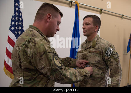 Maj. Michael Warren, 824th Base Defense Squadron commander, pins an achievement medal on Staff Sgt. David Green, 824th BDS fireteam leader, April 10, 2017, at Moody Air Force Base, Ga. Green received the medal for his act of heroism when he helped a trapped victim during an off-base vehicle incident. (U.S. Air Force photo by Airman 1st Class Lauren M. Sprunk) Stock Photo