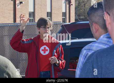 SCHREIVER AIR FORCE BASE, Colo. -- Sally Broomfield, Disaster Program Manager for Southeastern Colorado's American Red Cross, instructs 310th Space Wing volunteers on how to install fire alarms for families in the Cimarron Hills community during a Home Fire Campaign event on Saturday, Apr. 15th, 2017. The Red Cross responds to approximately 64,000 disasters each year with the vast majority being home fires, resulting in a goal to reduce fire-related deaths and injuries. (U.S. Air Force photo/Senior Airman Laura Turner) Stock Photo