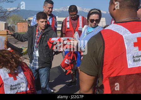 SCHREIVER AIR FORCE BASE, Colo. -- Southeastern Colorado's American Red Cross members hand safety vests out to 310th Space Wing volunteers who installed fire alarms for local families during a Home Fire Campaign event on Saturday, Apr. 15th, 2017. The Red Cross responds to approximately 64,000 disasters each year with the vast majority being home fires, resulting in a goal to reduce fire-related deaths and injuries. (U.S. Air Force photo/Senior Airman Laura Turner) Stock Photo