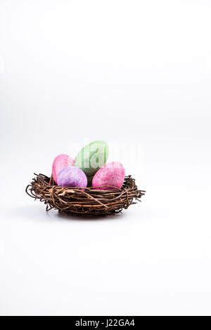 Colored Easter eggs in nest of grass isolated on white Stock Photo - Alamy