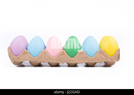 One dozen colored Easter eggs in a crate. Stock Photo