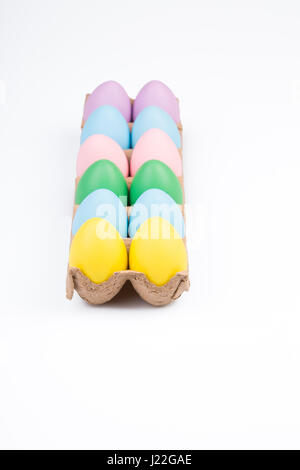 One dozen colored Easter eggs in a crate. Stock Photo