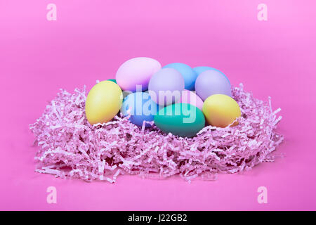Easter eggs in a nest with pink background. Stock Photo