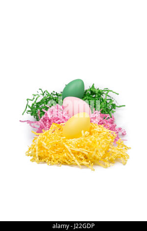 Colored Easter eggs in grass nest. Stock Photo