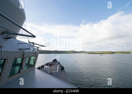 170417-N-ZE250-022   PLYMOUTH, United Kingdom (April 17, 2017) - USS Carney (DDG 64) leaves port in Plymouth, United Kingdom while participating in Flag Officer Sea Training (FOST) April 17, 2017. Carney, an Arleigh Burke-class guided-missile destroyer, forward-deployed to Rota, Spain, is conducting its third patrol in the U.S. 6th Fleet area of operations in support of U.S. national security interests in Europe. (U.S. Navy photo by Mass Communication Specialist 3rd Class Weston Jones/Released) Stock Photo