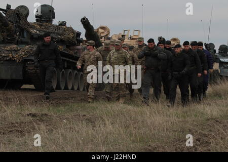 U.S. and Romanian soldiers march from their tanks in formation after a live fire training exercise at Smardan Training Area on April 19, 2017. Both forces have been training closely together as a part of Operation Atlantic Resolve, a NATO mission involving the U.S. and its European Allies and partners in a combined effort to strengthen friendships and promote peace in Eastern Europe. (Photo by Army Pvt. Nicholas Vidro, 7th Mobile Public Affairs Detachment) Stock Photo