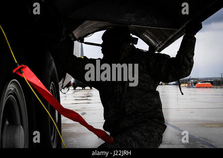 U.S. Air National Guard member Tech. Sgt. Kye Dudley from the 146th Maintenance Squadron inspects the landing gear of a C-130J aircraft at Gowen Field, Idaho, April 20, 2017. Sgt. Dudley and a maintenance crew from the 146th Airlift Wing will be providing maintenance service on two C-130J aircraft equipped with the Modular Airborne Fire Fighting System (MAFFS) from the Channel Islands Air National Guard Station during the week-long multi-agency wildfire training with the U.S. Forest Service, CAL FIRE, and multiple Air National Guard and U.S. Air Force Reserve wings. (U.S. Air National Guard ph Stock Photo