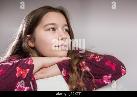 Portrait of an eleven year old girl looking thoughtful Stock Photo