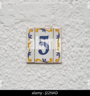 House number 5 sign in ceramic tiles on wall Stock Photo