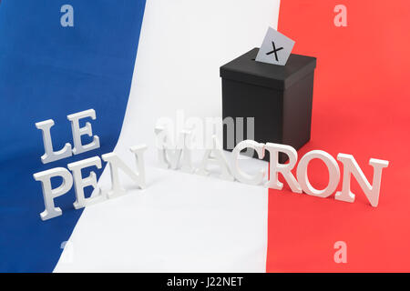 Small black box on French tricolor flag - as visual metaphor for the 2017 French General Election + Le Pen & Macron names Stock Photo