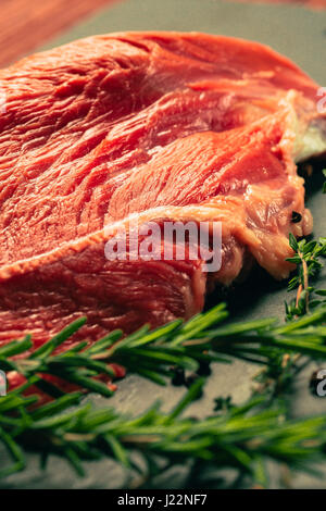 raw beef meat with spices on slate stone kitchen board Stock Photo