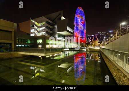 Barcelona, Spain - January 07 2017: Agbar tower reflected in the water with Design Museum in the foreground at night time Stock Photo
