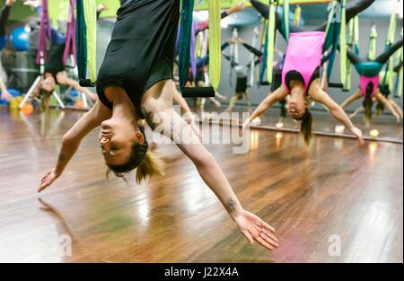 Group of women having a class of aerial yoga Stock Photo