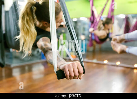 Group of women having a class of aerial yoga Stock Photo