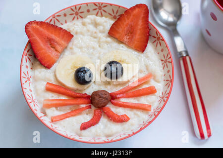 Oatmeal porridge with a kitten face decoration Stock Photo