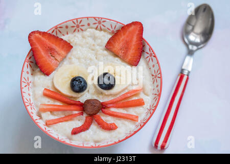 Oatmeal porridge with a kitten face decoration Stock Photo