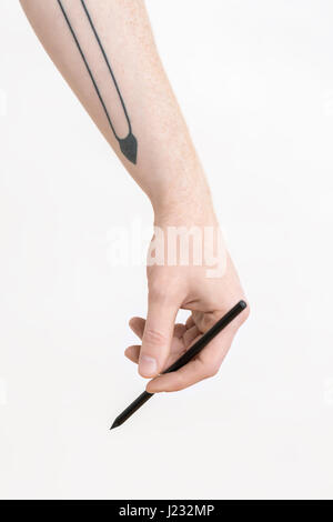 Hand with black pencil Stock Photo