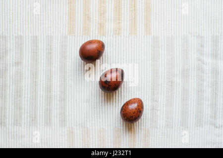Three small quail eggs, home made painting, Easter holiday Stock Photo